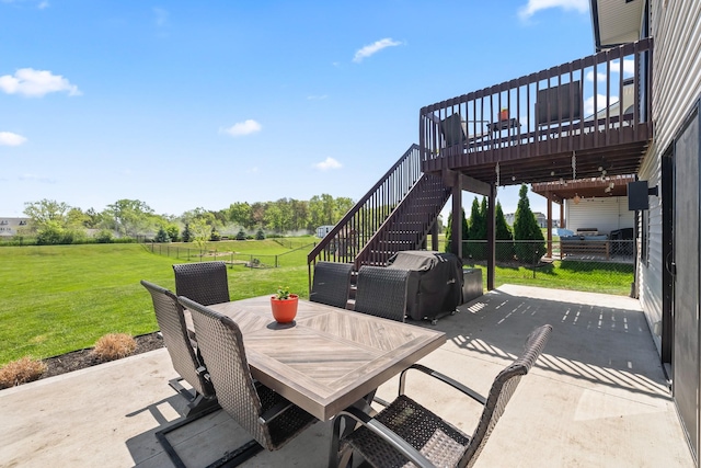 view of patio / terrace with stairs, outdoor dining area, and a wooden deck