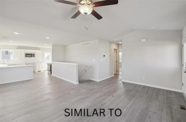 928 Spruce Ave, Norwalk, IA 50211 - unfurnished living room featuring light wood finished floors, ceiling fan, lofted ceiling, and recessed lighting