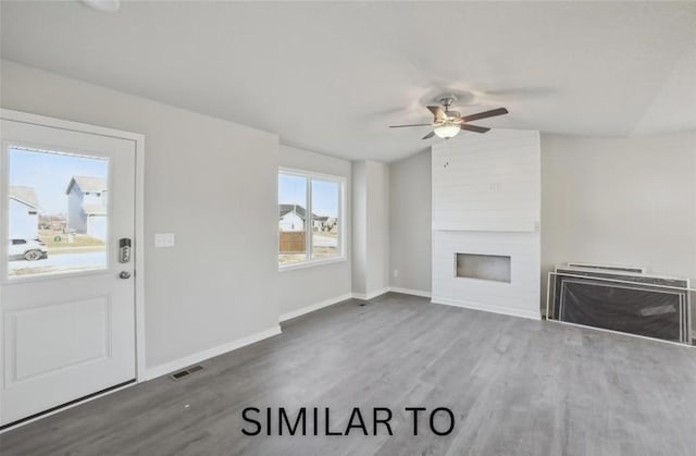 928 Spruce Ave, Norwalk, IA 50211 - unfurnished living room with a large fireplace, wood finished floors, ceiling fan, and lofted ceiling
