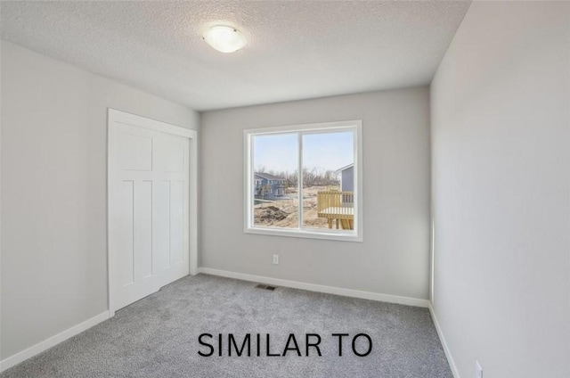 928 Spruce Ave, Norwalk, IA 50211 - unfurnished bedroom with carpet floors and a textured ceiling