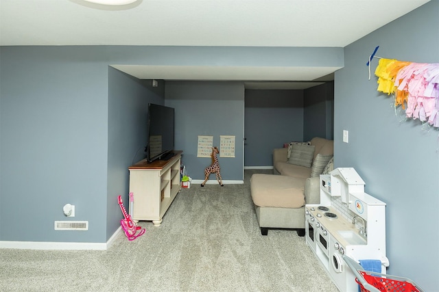 sitting room featuring carpet flooring and baseboards