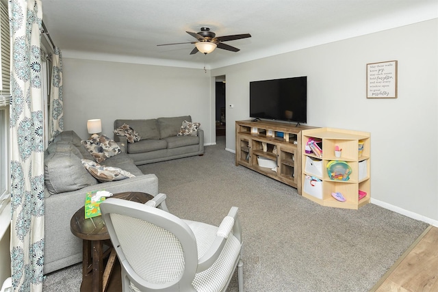 living room featuring ceiling fan and baseboards