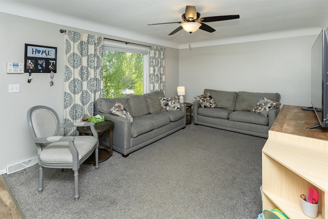 living area featuring a ceiling fan and wood finished floors