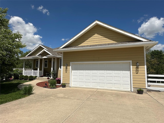 711 E Madison St, Winterset, IA 50273 - single story home featuring driveway, a porch, and a garage