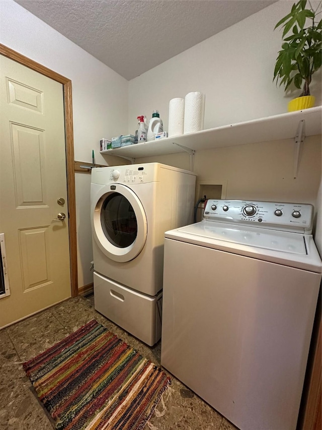 711 E Madison St, Winterset, IA 50273 - laundry area with separate washer and dryer and a textured ceiling
