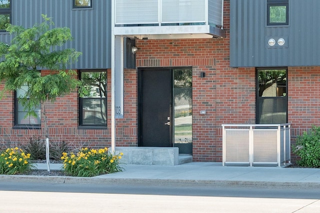 property entrance featuring brick siding