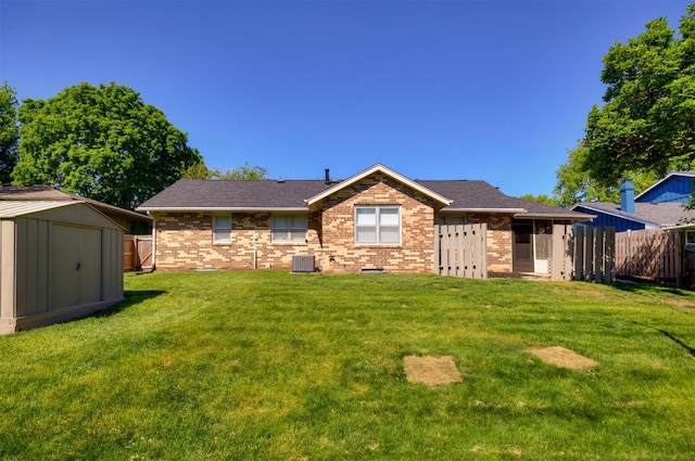1667 NW 93rd Ct, Clive, IA 50325 - back of house featuring central air condition unit, brick siding, a shed, an outdoor structure, and a shingled roof