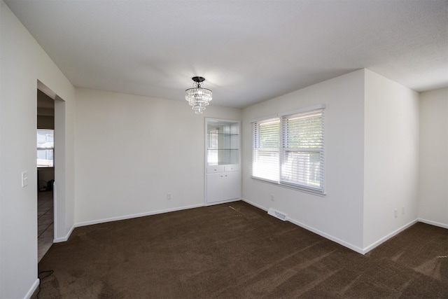 1667 NW 93rd Ct, Clive, IA 50325 - carpeted empty room featuring a chandelier and baseboards