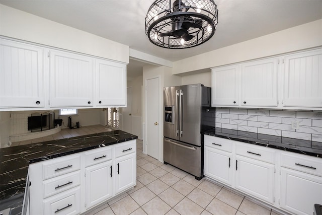 1667 NW 93rd Ct, Clive, IA 50325 - kitchen featuring stainless steel fridge with ice dispenser, decorative backsplash, and white cabinets