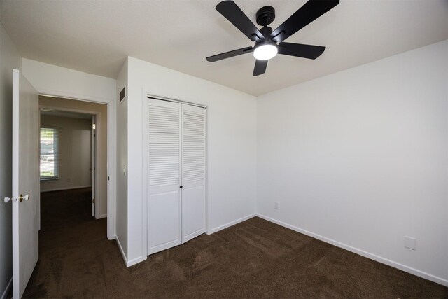 1667 NW 93rd Ct, Clive, IA 50325 - unfurnished bedroom featuring dark colored carpet, a closet, and baseboards