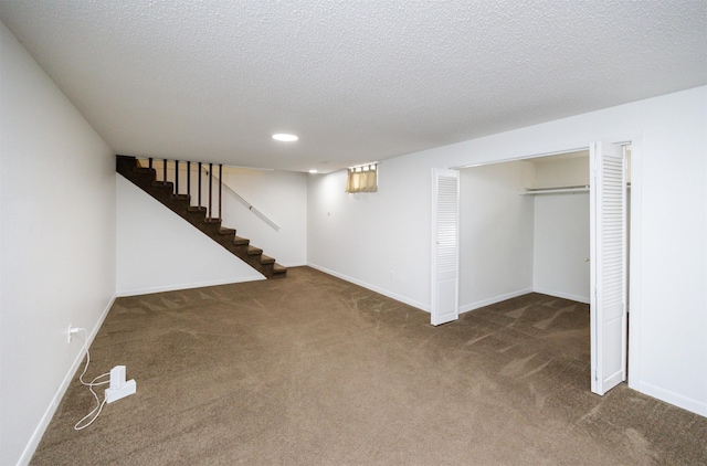 1667 NW 93rd Ct, Clive, IA 50325 - finished below grade area featuring carpet flooring, baseboards, recessed lighting, a textured ceiling, and stairs