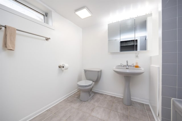 1667 NW 93rd Ct, Clive, IA 50325 - bathroom featuring toilet, tile patterned flooring, baseboards, and a sink