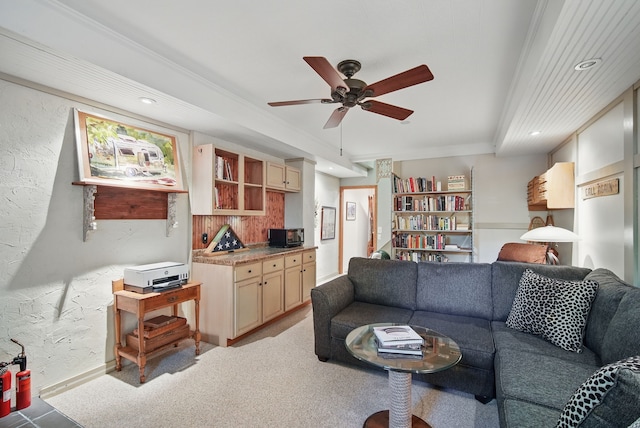 living area with ceiling fan, crown molding, recessed lighting, and a textured wall