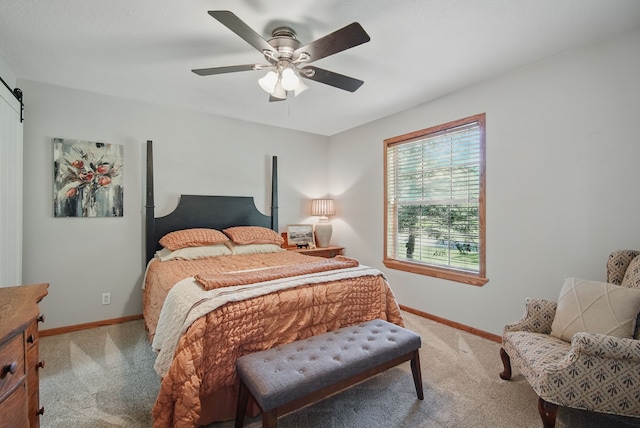 bedroom featuring light colored carpet, baseboards, and a ceiling fan