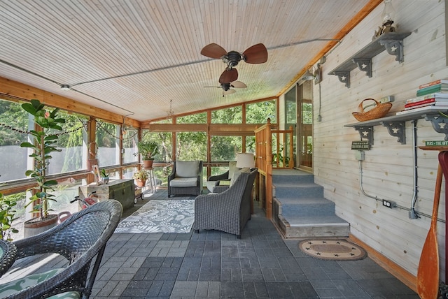 sunroom featuring ceiling fan, lofted ceiling, and an outdoor living space