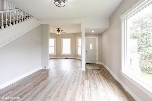 foyer featuring ceiling fan, light wood finished floors, and baseboards