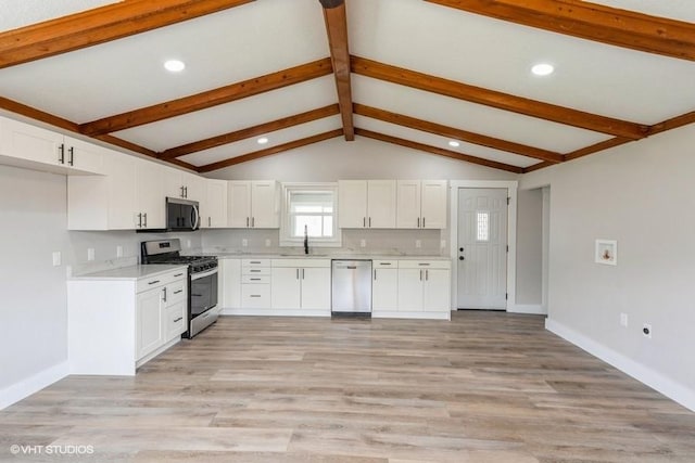kitchen with stainless steel appliances, a sink, light countertops, white cabinetry, and recessed lighting