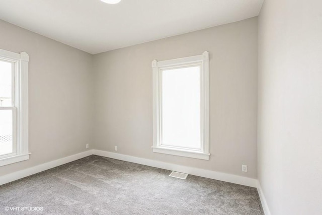 carpeted empty room with baseboards