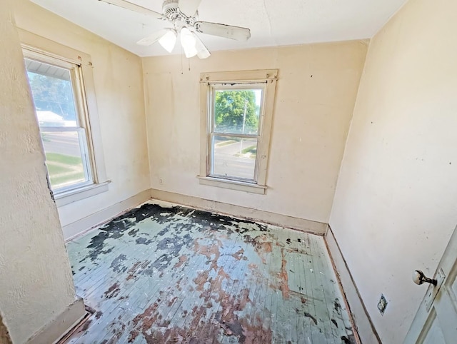 unfurnished room with baseboards and ceiling fan