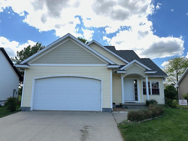 322 N 15th Ave, Winterset, IA 50273 - view of front of property featuring driveway, a garage, and a shingled roof