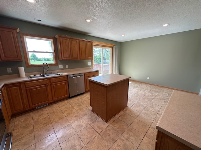 322 N 15th Ave, Winterset, IA 50273 - kitchen featuring stainless steel dishwasher, a sink, a textured ceiling, light tile patterned floors, and a kitchen island