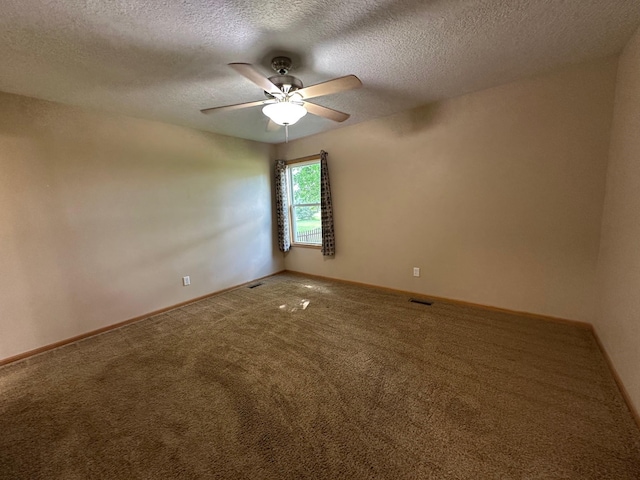 322 N 15th Ave, Winterset, IA 50273 - carpeted empty room featuring ceiling fan, a textured ceiling, and baseboards