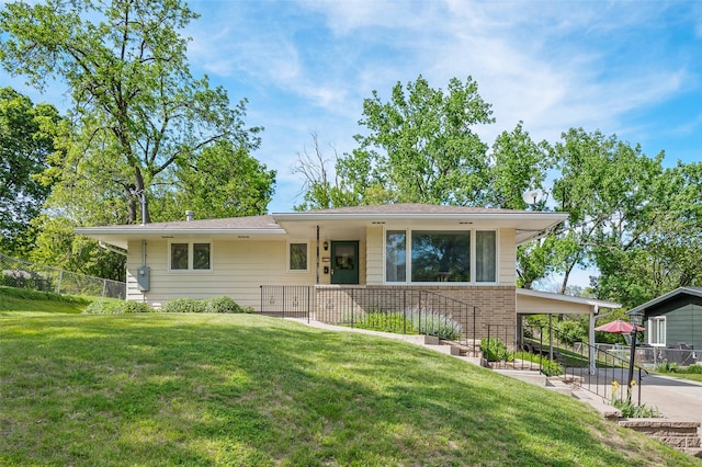 view of front of property featuring a carport and brick siding