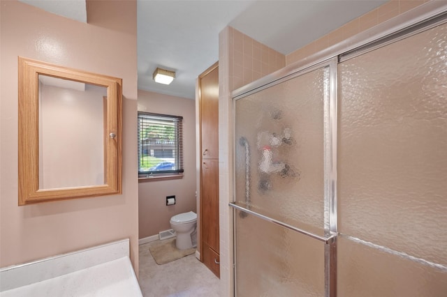 full bath with a stall shower and toilet