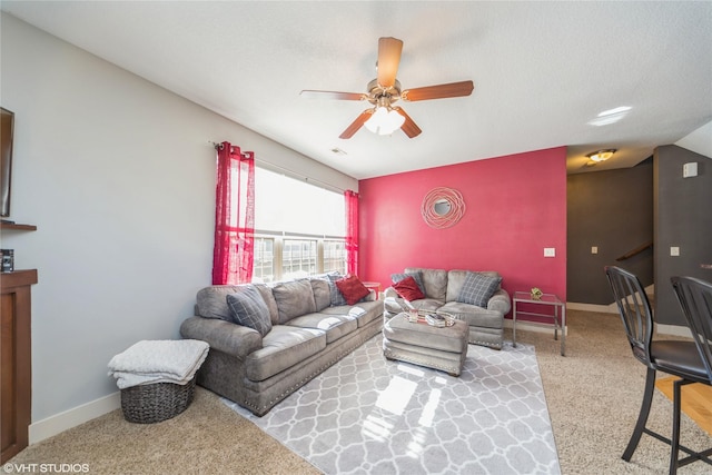 living room with ceiling fan, carpet flooring, and baseboards