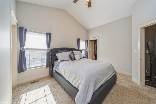 bedroom featuring vaulted ceiling, carpet floors, ceiling fan, baseboards, and a walk in closet
