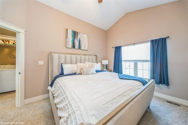 bedroom with carpet, lofted ceiling, baseboards, and washer / dryer