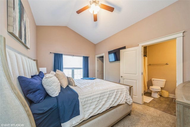 carpeted bedroom with vaulted ceiling, ensuite bathroom, ceiling fan, and tile patterned flooring