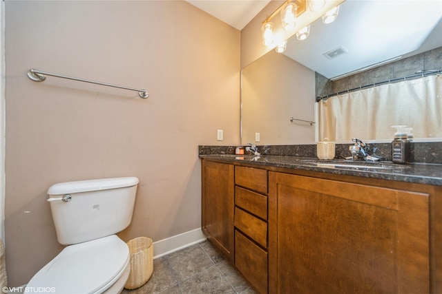 bathroom with baseboards, toilet, double vanity, tile patterned flooring, and a shower with curtain