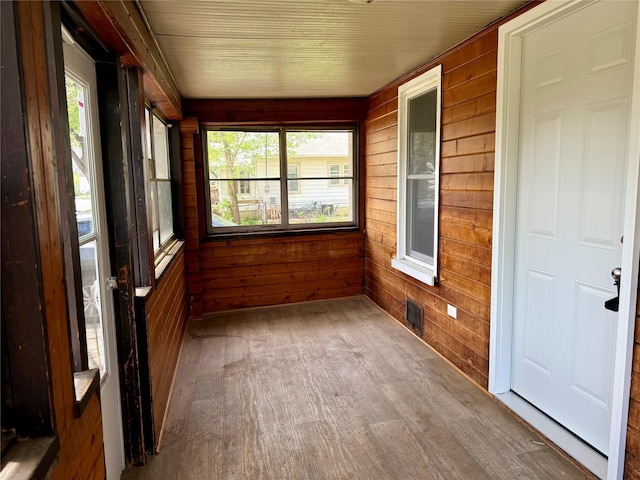 2036 Capitol Ave, Des Moines, IA 50317 - unfurnished sunroom with wood finished floors and wooden walls