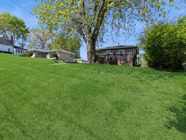 view of grassy yard featuring a deck