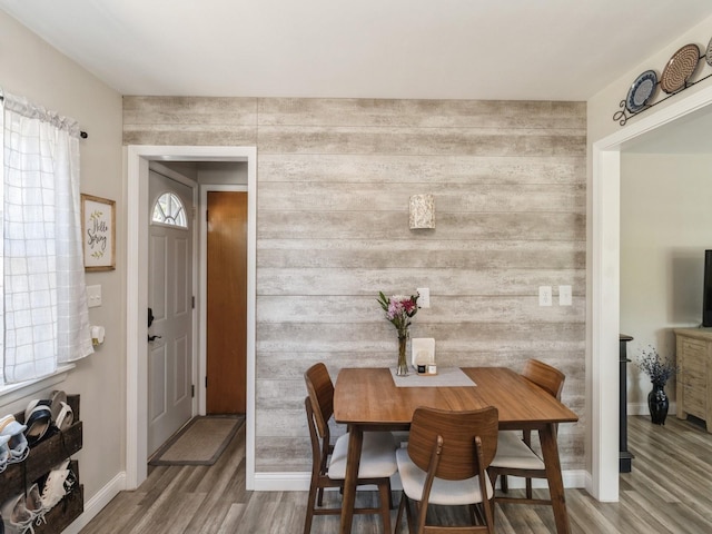 dining area featuring wood finished floors and baseboards