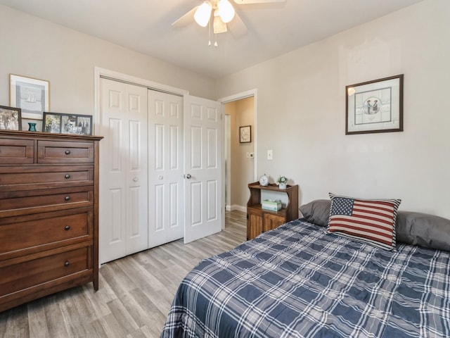 bedroom featuring light wood-style flooring, a closet, and ceiling fan