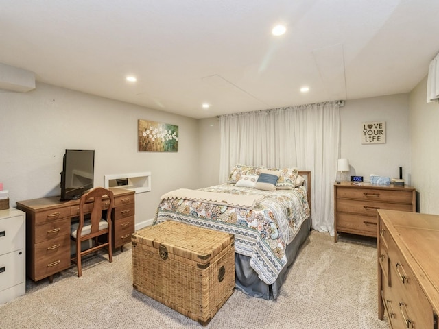 bedroom with light colored carpet, recessed lighting, and an office area