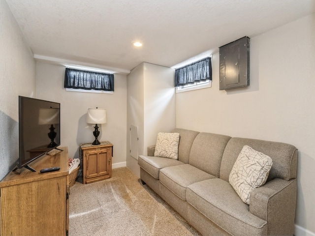 living area with electric panel, light carpet, recessed lighting, and baseboards