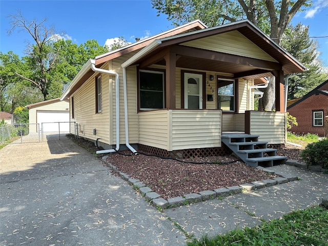 3429 54th St, Des Moines, IA 50310 - view of front of house with covered porch, a garage, an outbuilding, and fence