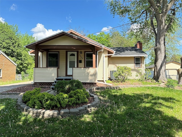3429 54th St, Des Moines, IA 50310 - view of front of home featuring a chimney, a front lawn, and covered porch
