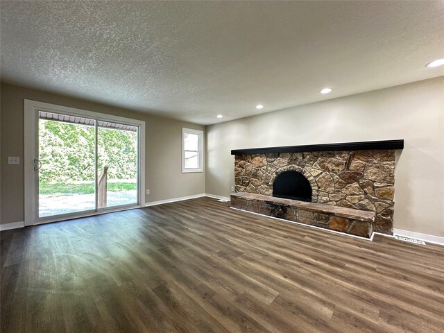 3429 54th St, Des Moines, IA 50310 - unfurnished living room featuring baseboards, a textured ceiling, wood finished floors, a fireplace, and recessed lighting