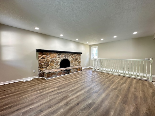 3429 54th St, Des Moines, IA 50310 - unfurnished living room with baseboards, a textured ceiling, wood finished floors, recessed lighting, and a fireplace