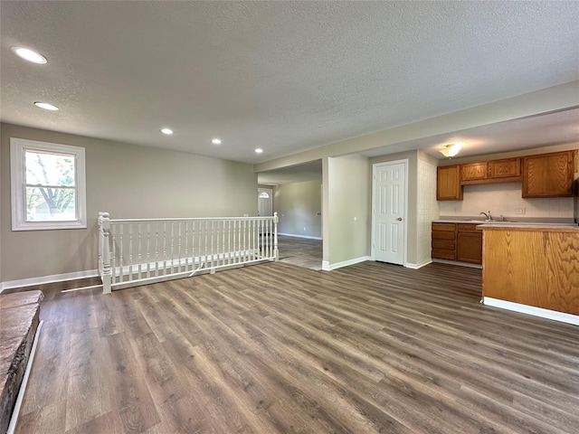 3429 54th St, Des Moines, IA 50310 - unfurnished living room featuring a textured ceiling, dark wood finished floors, baseboards, and recessed lighting