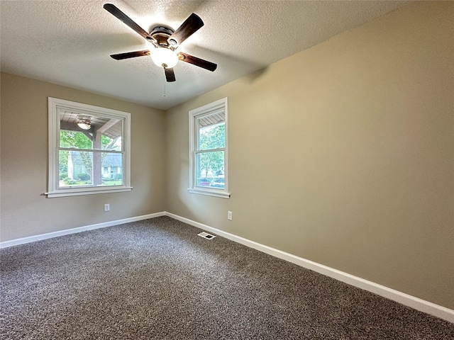 3429 54th St, Des Moines, IA 50310 - spare room featuring a ceiling fan, dark carpet, a textured ceiling, and baseboards