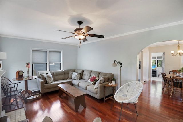 living area featuring arched walkways, a chandelier, dark wood-style floors, ornamental molding, and a ceiling fan