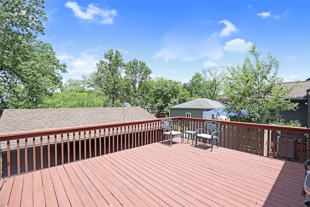wooden terrace with view of scattered trees