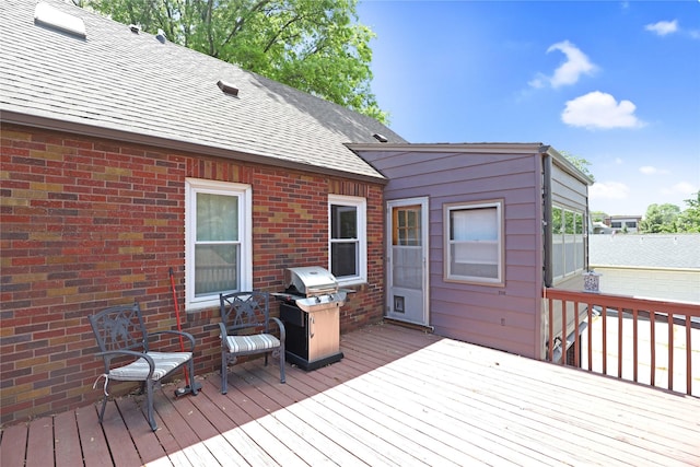 wooden terrace with area for grilling and fence