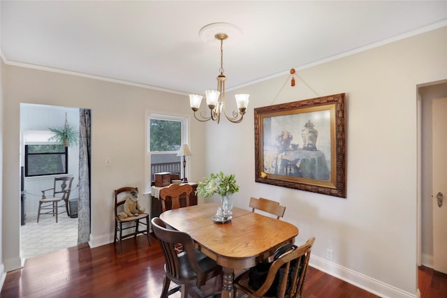 dining space with a chandelier, ornamental molding, dark wood finished floors, and baseboards