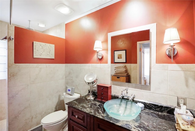 bathroom featuring tile walls, vanity, and toilet